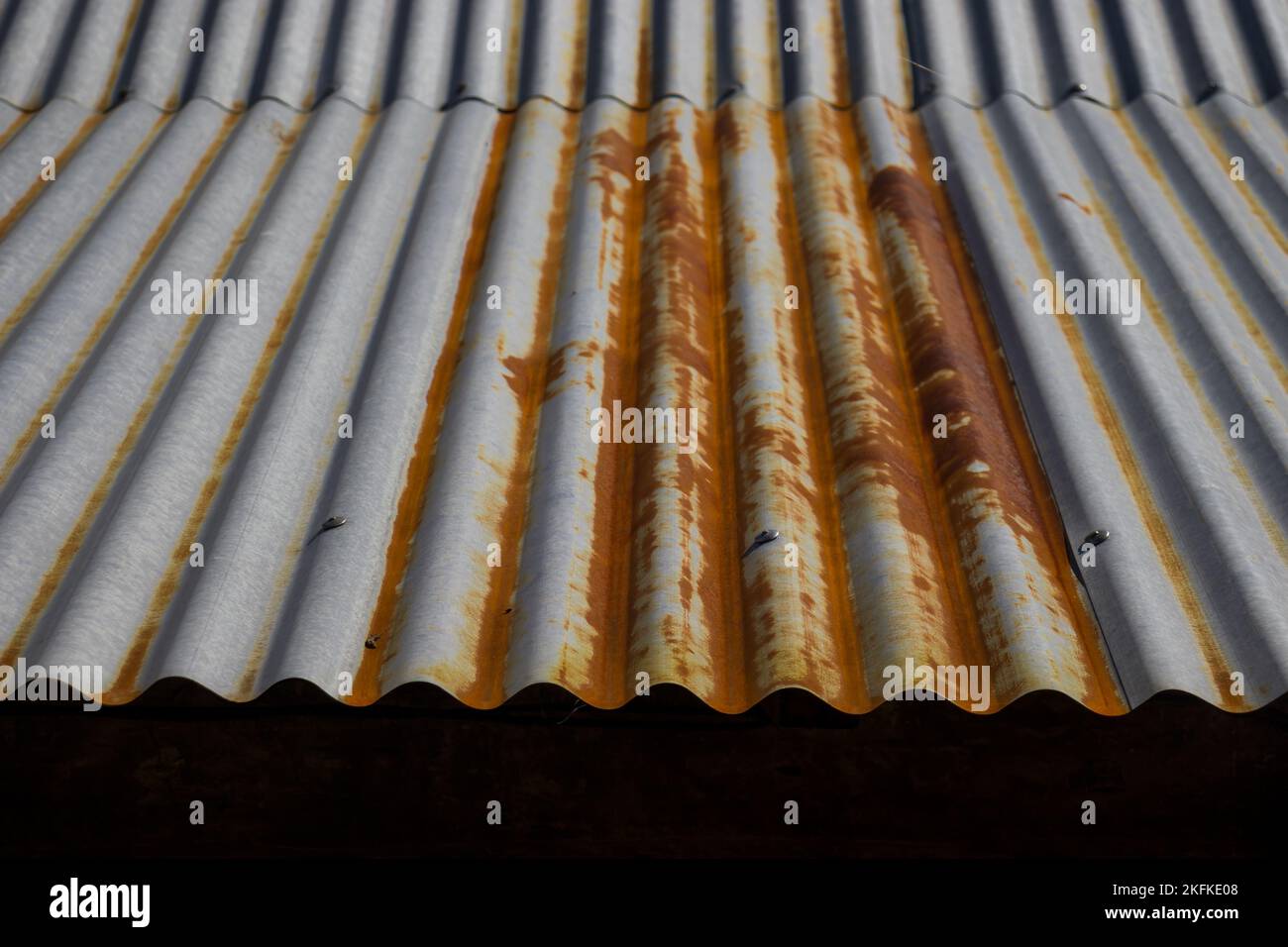 A closeup of a rusty steel roofing sheet texture in daylight Stock Photo