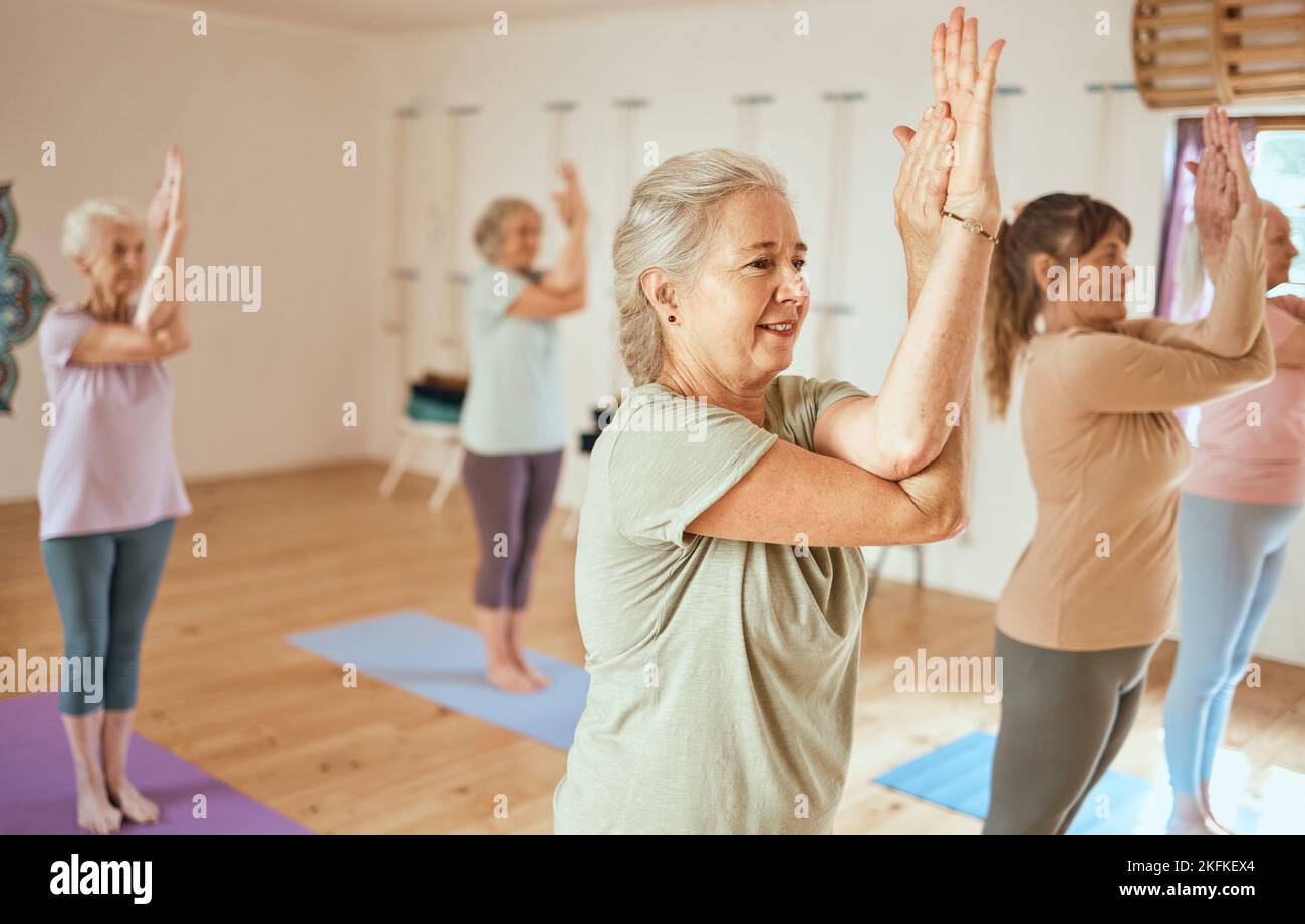 Pilates, wellness and group of senior women doing a mind, body and spiritual exercise in studio. Health, retirement and elderly friends doing yoga Stock Photo