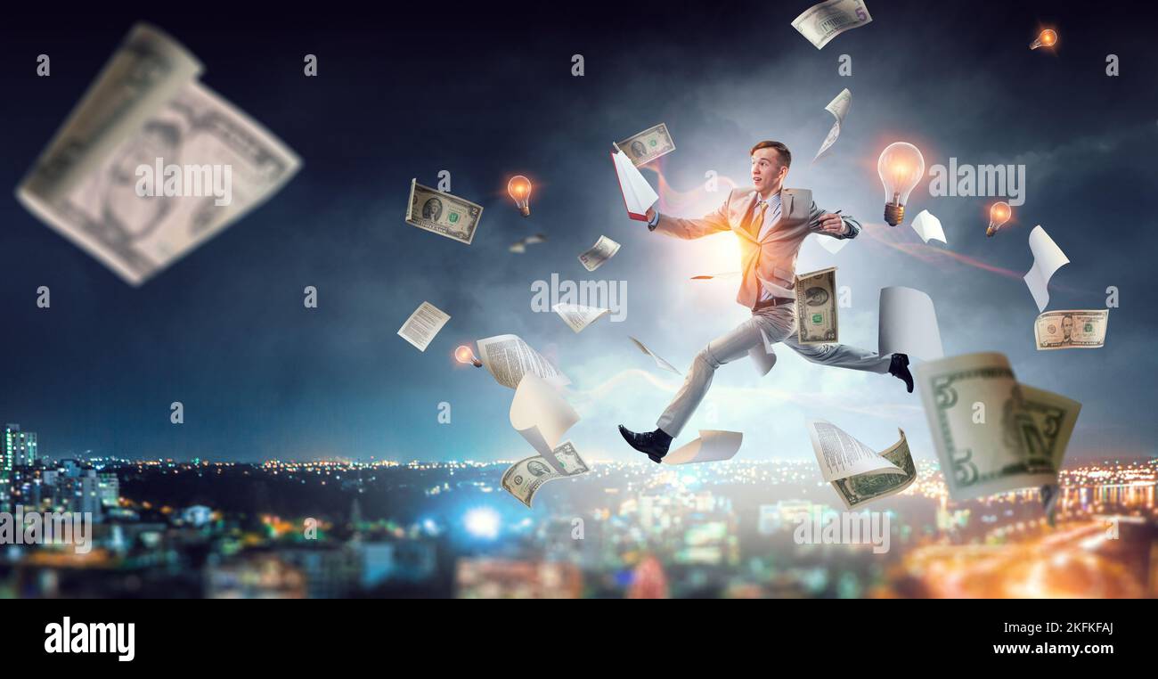 Portrait of energetic businessman jumping in open air Stock Photo