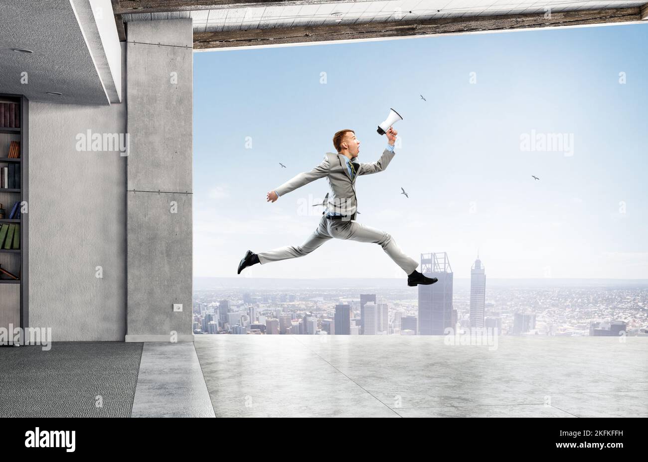 Portrait of energetic businessman jumping in open air Stock Photo