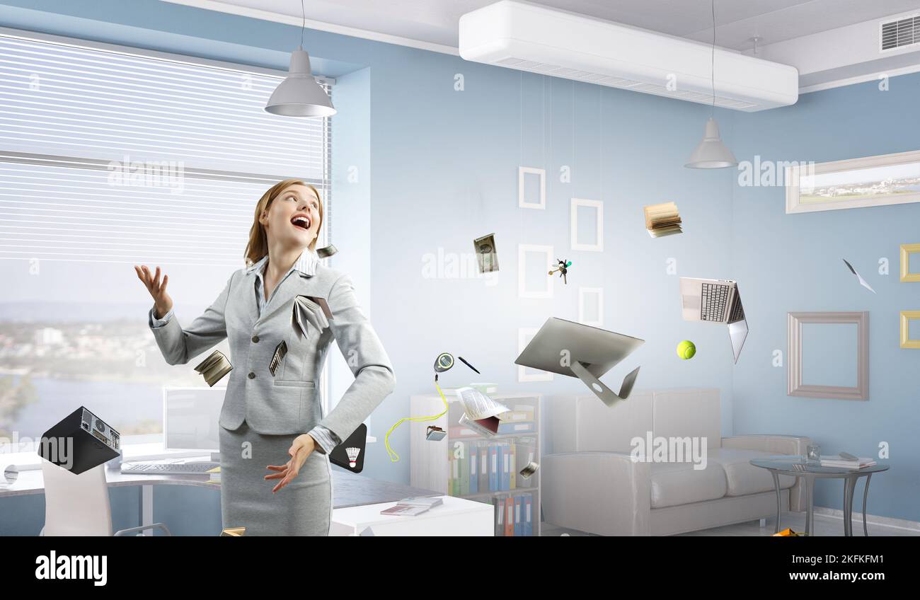 Young pretty businesswoman juggling with business items Stock Photo