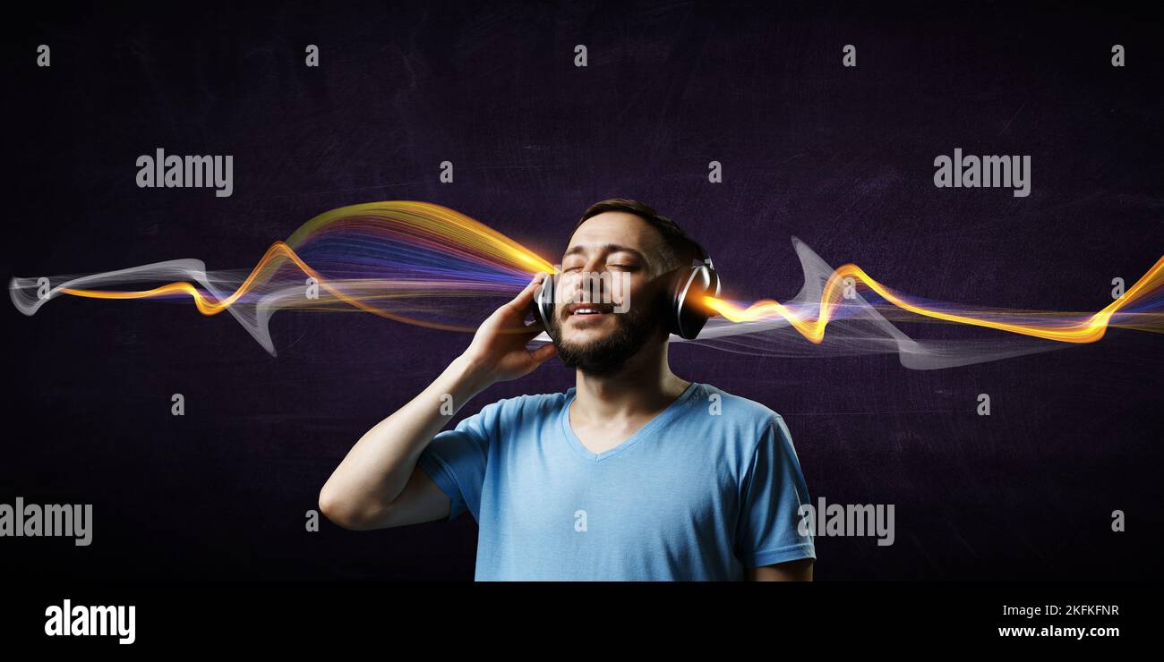 Young man with headphones . Mixed media Stock Photo