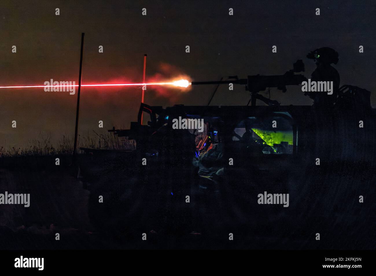 A United Kingdom Royal Marine from 45 Commando fires an M2 .50 caliber machine gun during a live-fire exercise at Grafenwöhr Training Area, Germany, Sept. 22, 2022. This Special Forces-led exercise is designed to improve their ability to work with the United Kingdom’s commando forces in a time of crisis. Stock Photo