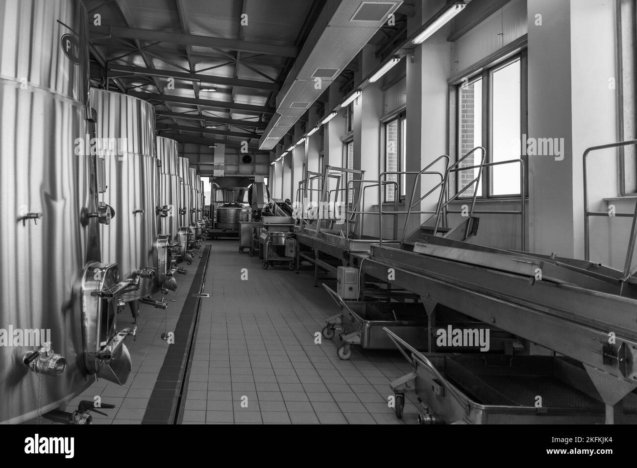 A grayscale of a winemaking factory with steel facilities in Cotnari
