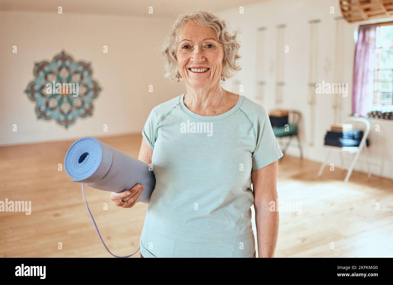 Portrait, elderly woman and mat for yoga, fitness and exercise at studio, happy and relax for cardio wellness. Smile, active senior and lady Stock Photo