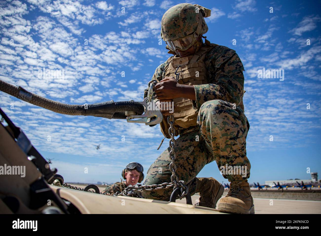 U.S. Marine Corps Lance Cpl. Daevon Robinson, a landing support specialist with Helicopter Support Team, 1st Landing Battalion, 1st Marine Logistics Group, works to recover a Joint Light Tactical Vehicle during the Marine Air-Ground Task Force demonstration of the 2022 Marine Corps Air Station Miramar Air Show at MCAS Miramar, San Diego, California, Sept. 24, 2022. The MAGTF Demo displays the coordinated use of close-air support, armor, artillery and infantry forces and provides a visual representation of how the Marine Corps operates. The theme for the 2022 MCAS Miramar Air Show, “Marines Fig Stock Photo