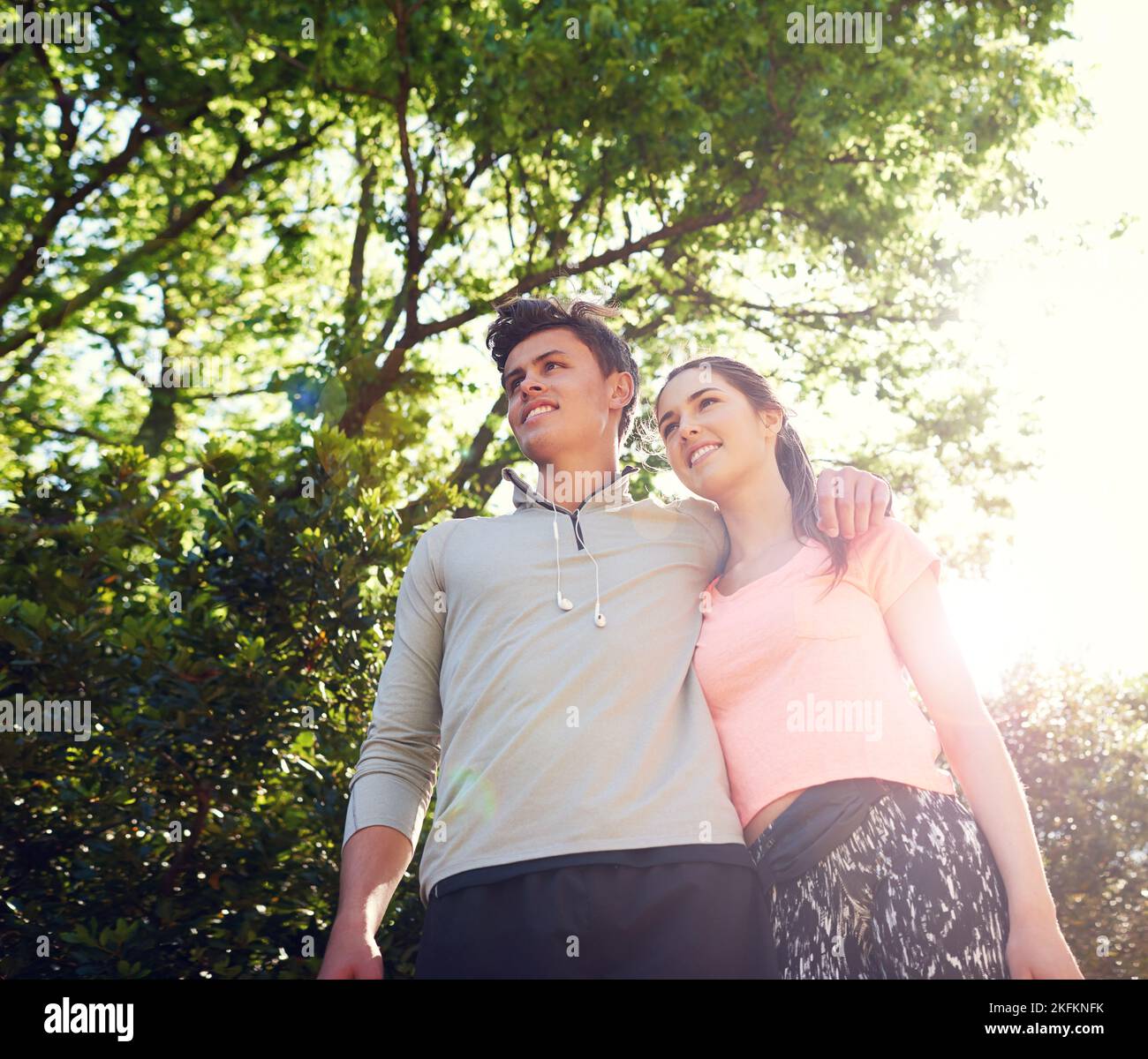 They love taking long walks together...a sporty young couple walking together in nature. Stock Photo
