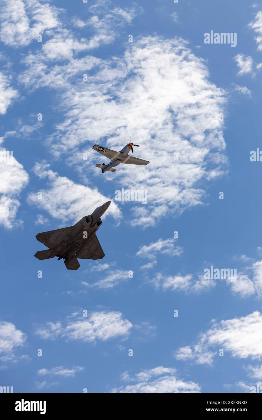 A U.S. Air Force F-22 Raptor and a P-51D Mustang conduct a heritage flight during the 2022 Marine Corps Air Station Miramar Air Show at MCAS Miramar, San Diego, California, Sept. 24, 2022. The F-22 Raptor is the Air Force's fifth-generation fighter aircraft. Its combination of stealth, supercruise, maneuverability, and integrated avionics, coupled with improved supportability, represents an exponential leap in warfighting capabilities. The theme for the 2022 MCAS Miramar Air Show, “Marines Fight, Evolve and Win,” reflects the Marine Corps’ ongoing modernization efforts to prepare for future co Stock Photo