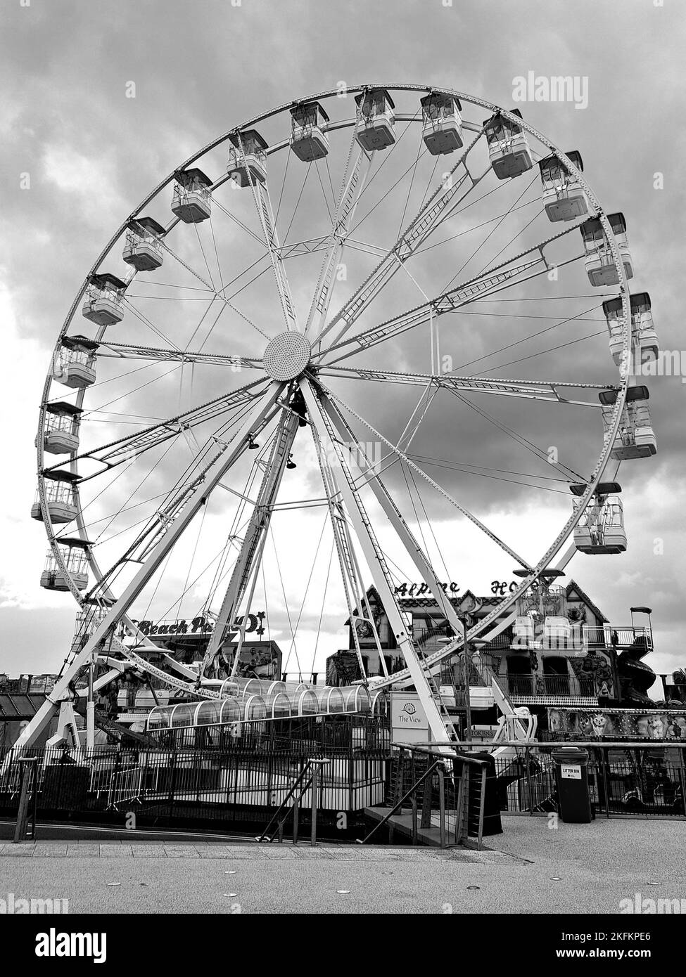 A vertical grayscale of the Ferris wheel in the fun fair Stock Photo
