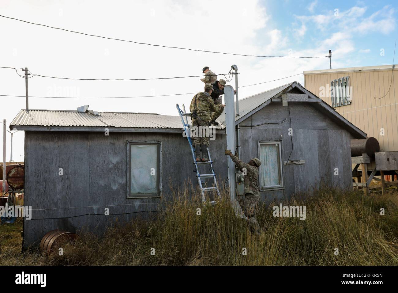 Service members with Joint Task Force Bethel assist local residents
