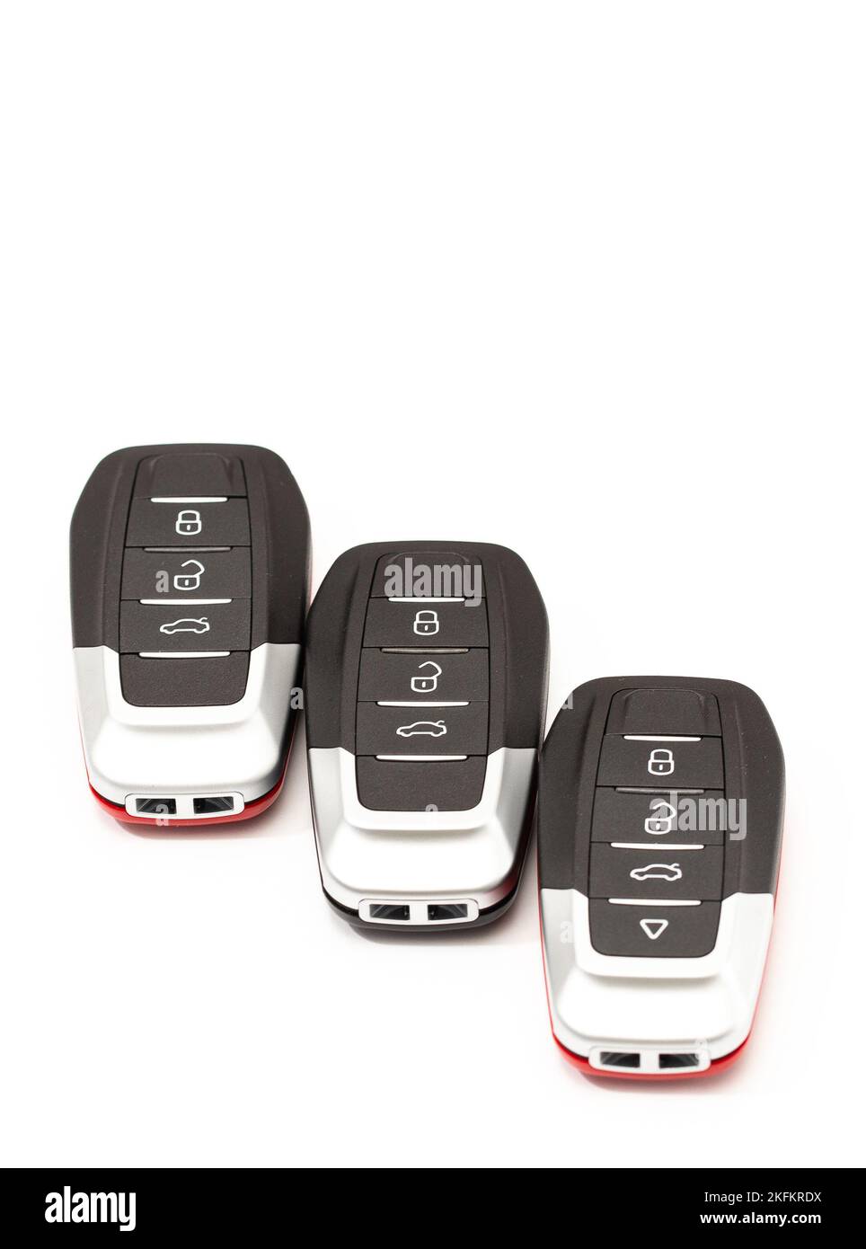Car keys lie in different poses on a white background. Black and red