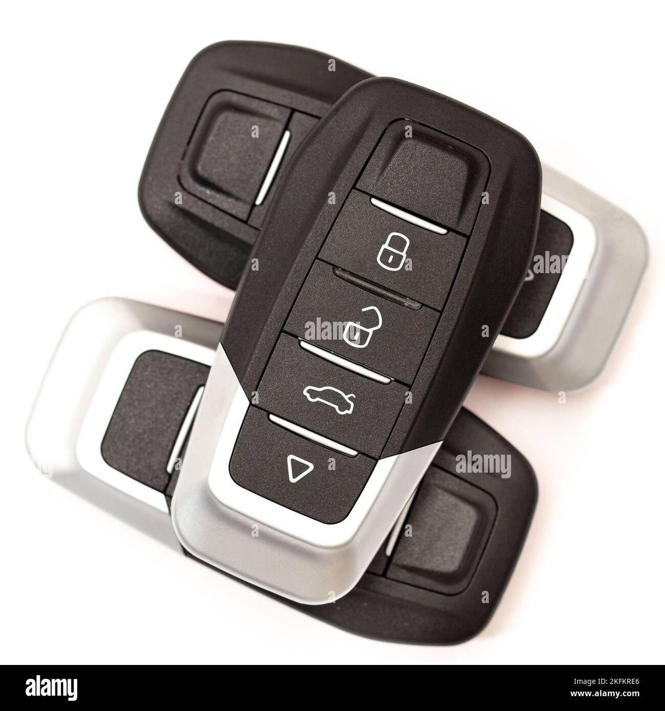 Car keys lie in different poses on a white background. Black and red