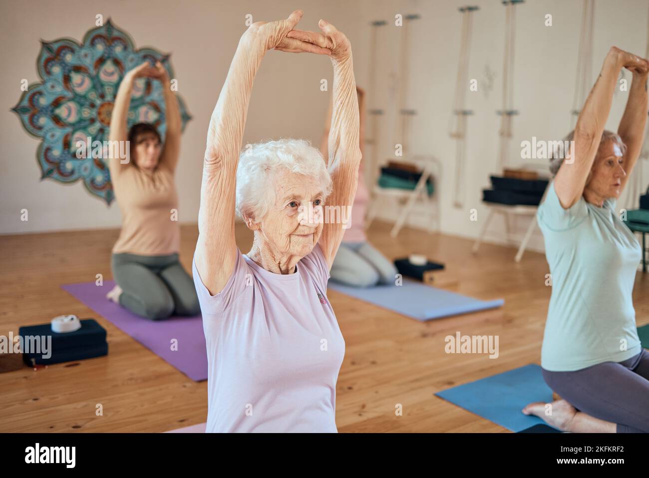 Elderly woman, yoga and stretching in class for healthy spiritual, mind ...