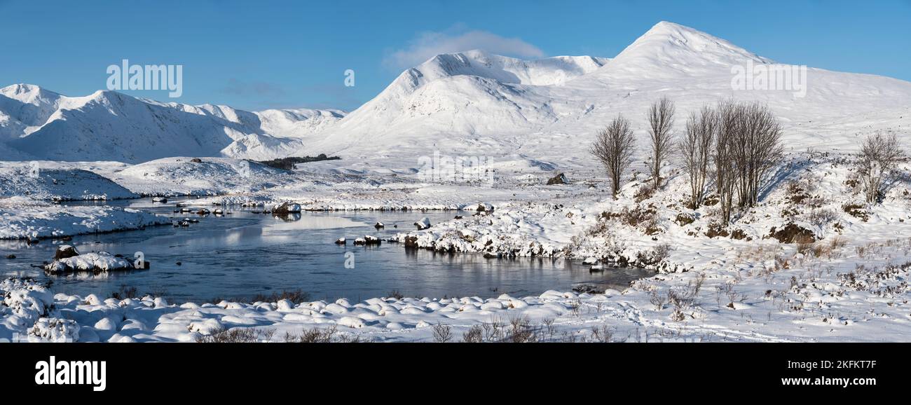 Majestic Winter landscape image looking towards Scottish Highlands mountain range across Loch Ba on Rannoch Moor Stock Photo