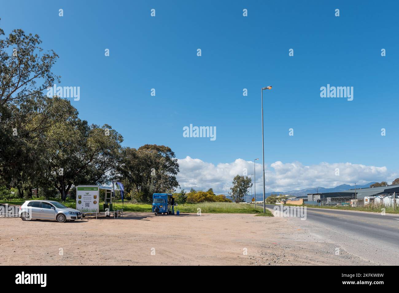 Somerset West, South Africa - Sep 19, 2022: A street scene in Main Road in Somerset West in the Western Cape Province. Two mobile kiosks and vehicles Stock Photo