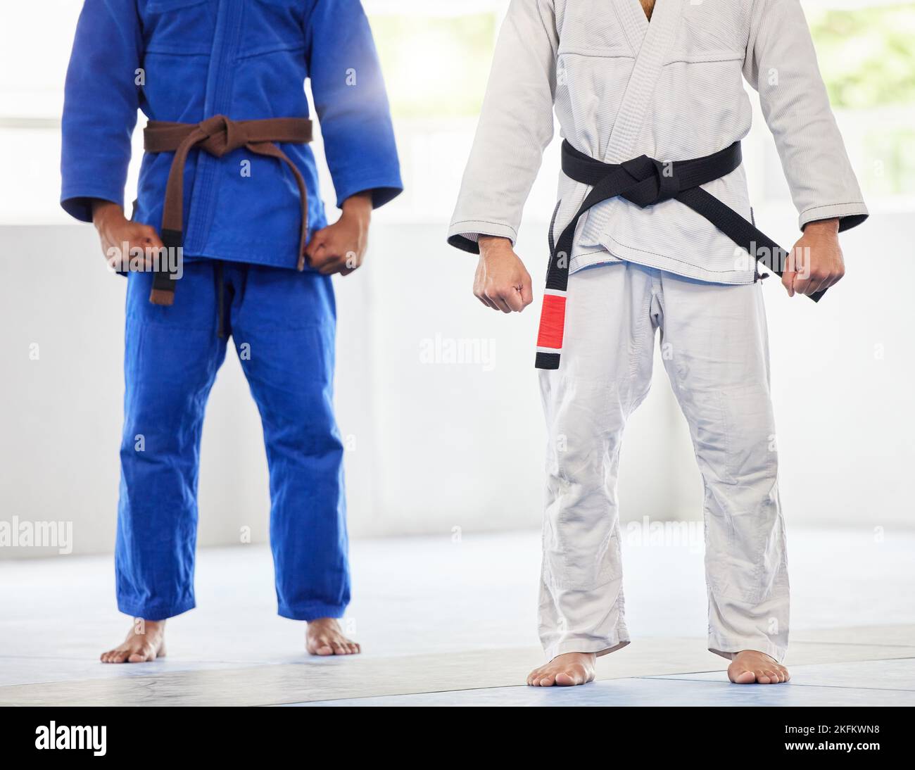 Karate, uniform and men in dojo, uniform and start training, exercise and workout with commitment and motivation. Fighter, uniform and coach with Stock Photo