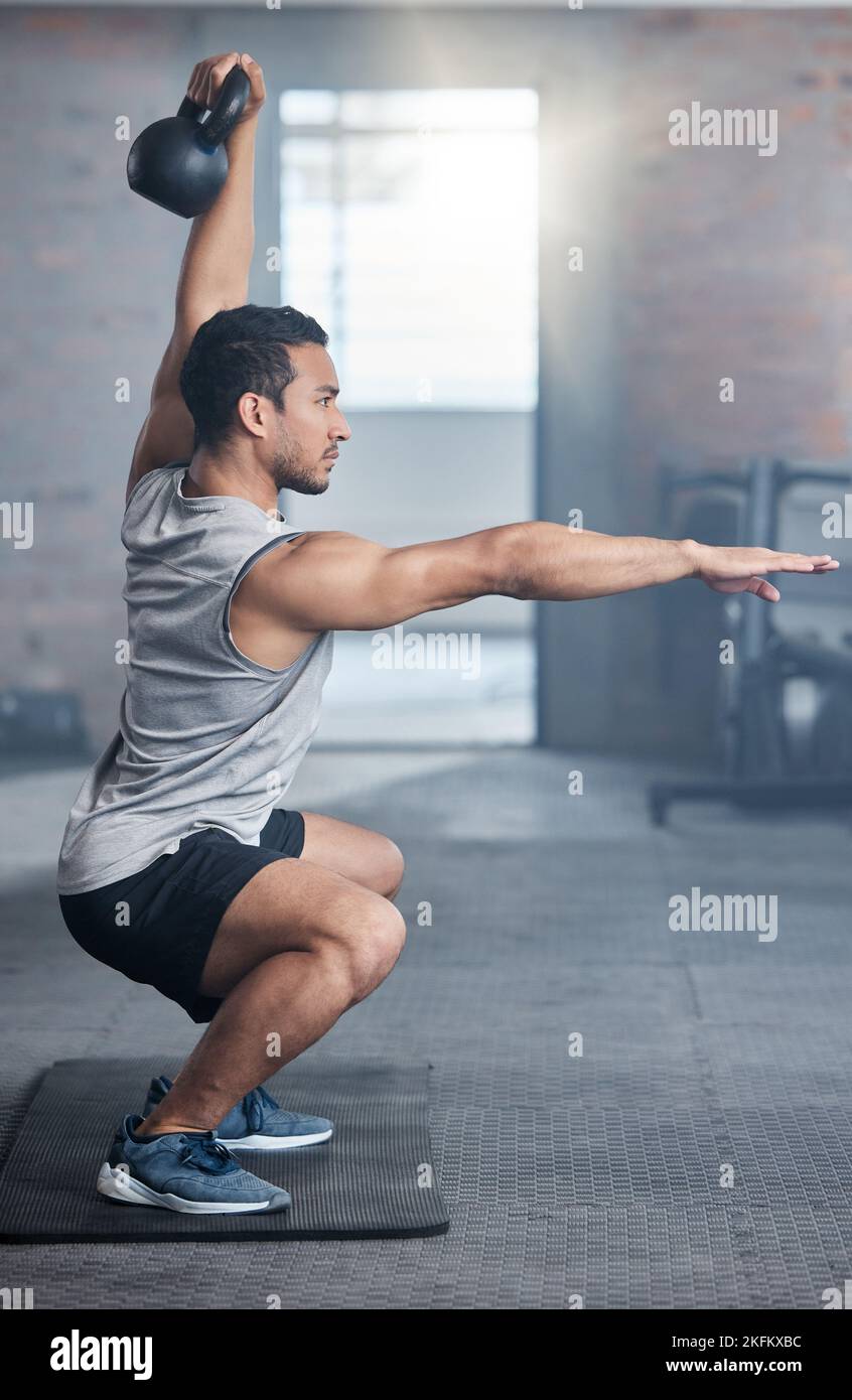 Fitness, focus and man with weights for strength training, exercise and workout in the gym. Power, strong and athlete training his body for health Stock Photo