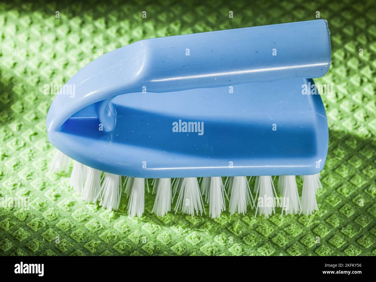 Blue plastic brush on green washcloth. Stock Photo