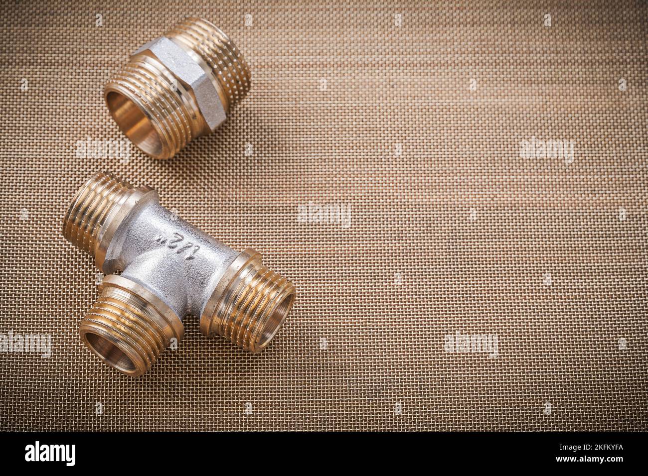 Brass plumber fixtures pipe fittings on water mesh filter Stock Photo