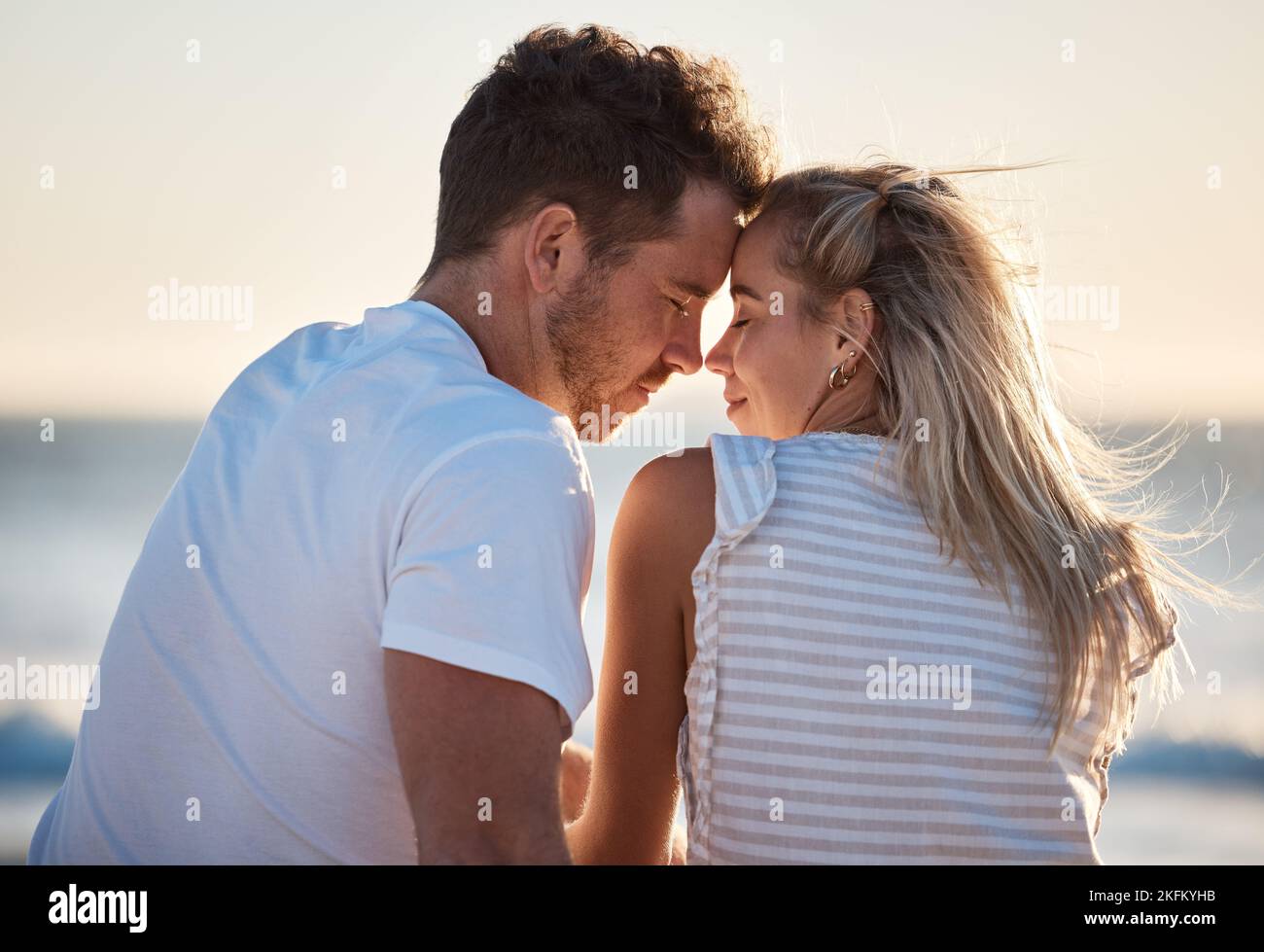Love, beach and couple with head together enjoying romantic holiday ...