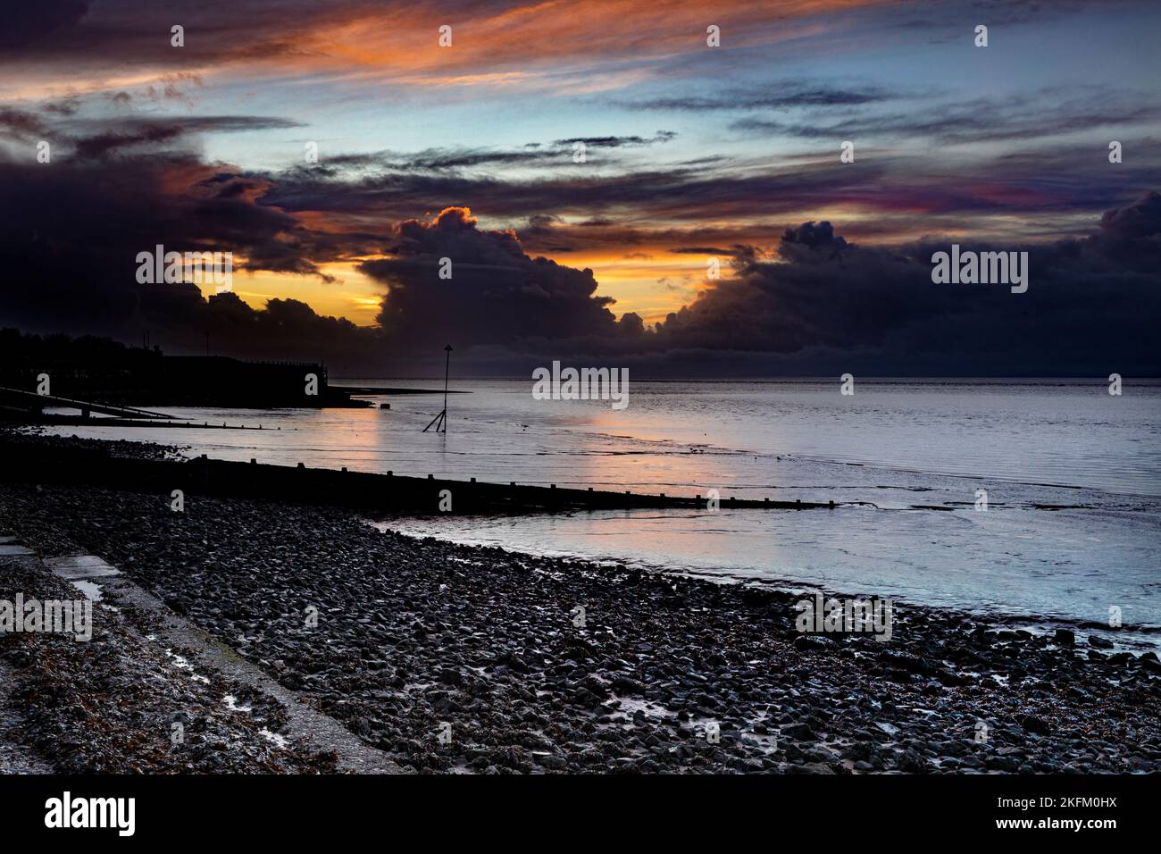 A vivid sunset over the Solway Firth taken from Silloth. Stock Photo