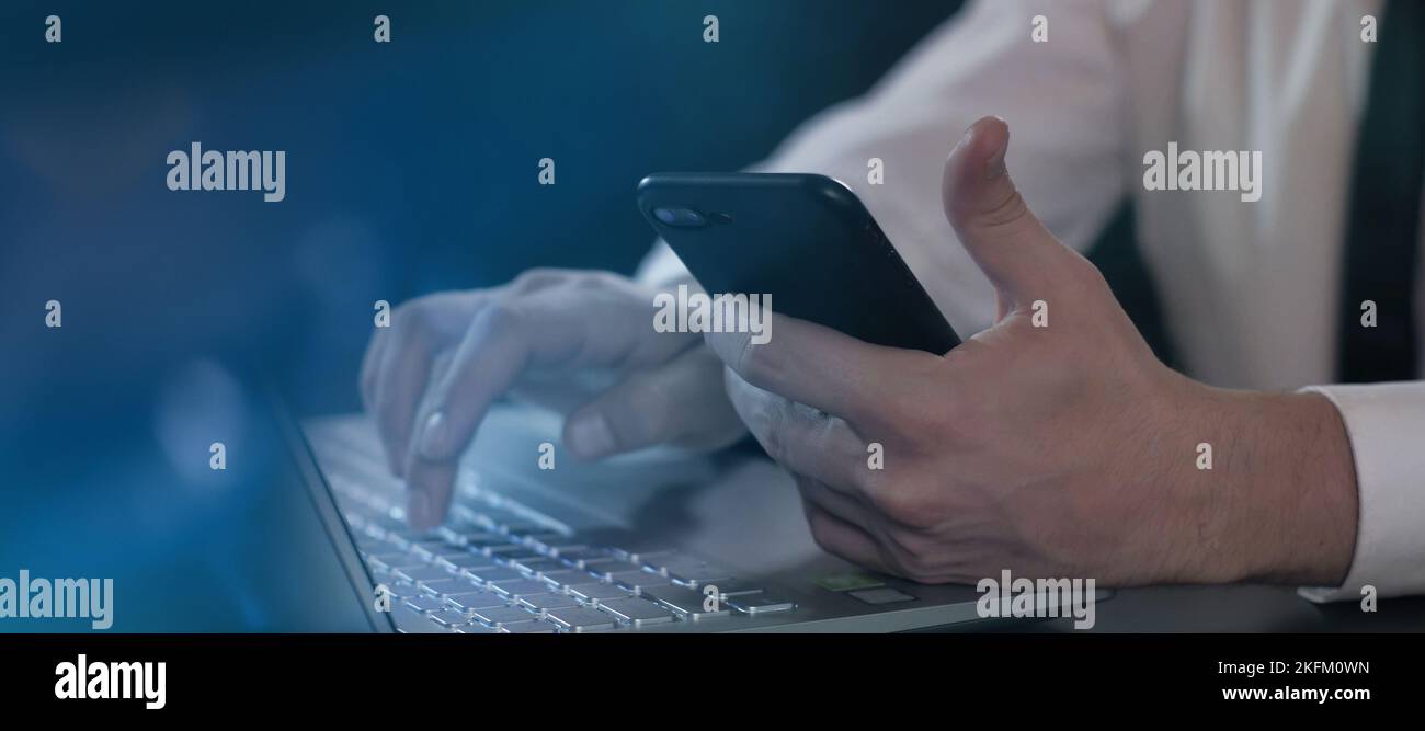 Working with mobile phone and laptop computer Stock Photo - Alamy