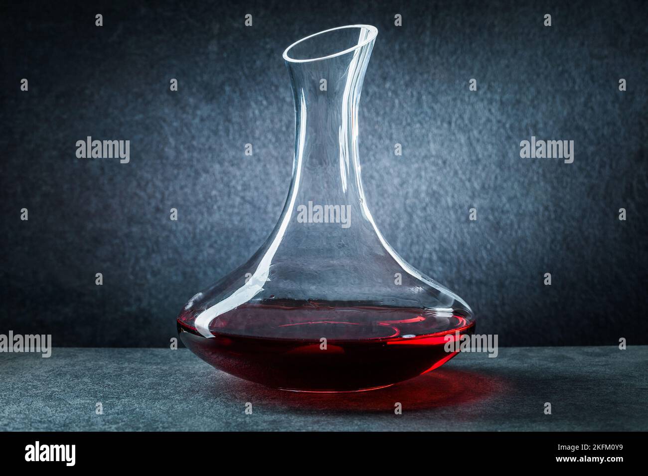 classic glass decanter with red wine on black background Stock Photo