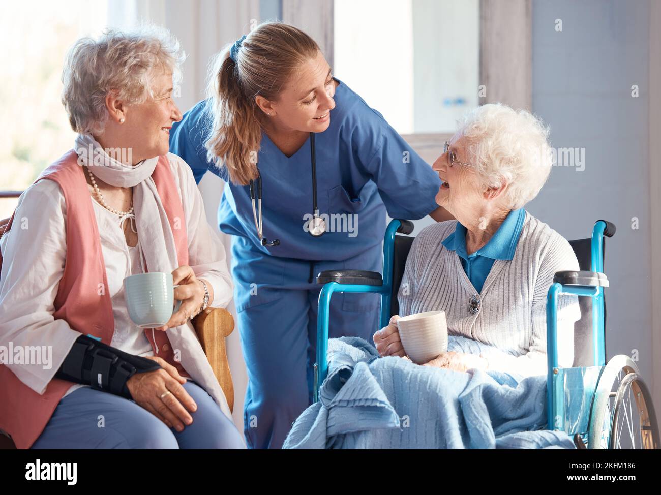 Nursing home, care and nurse with senior women doing healthcare checkup, examination or consultation. Medical, conversation and elderly woman in Stock Photo