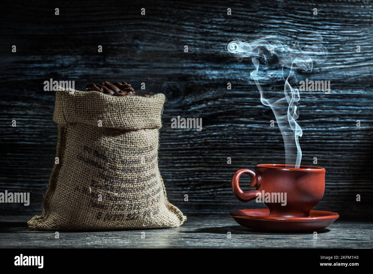 coffee cup with steam and sack of beans Stock Photo
