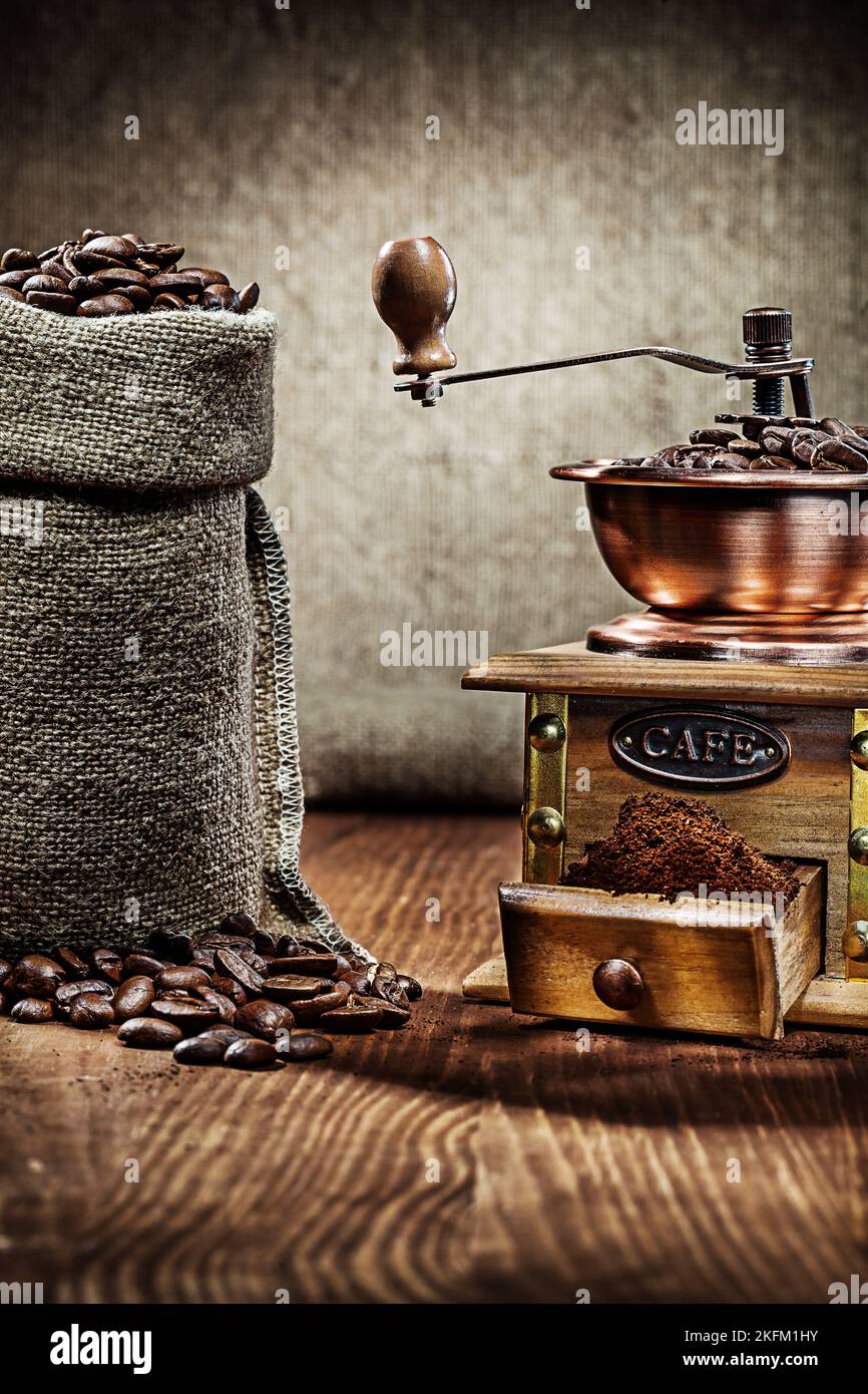 coffee mill and burlap sack with coffee beans Stock Photo