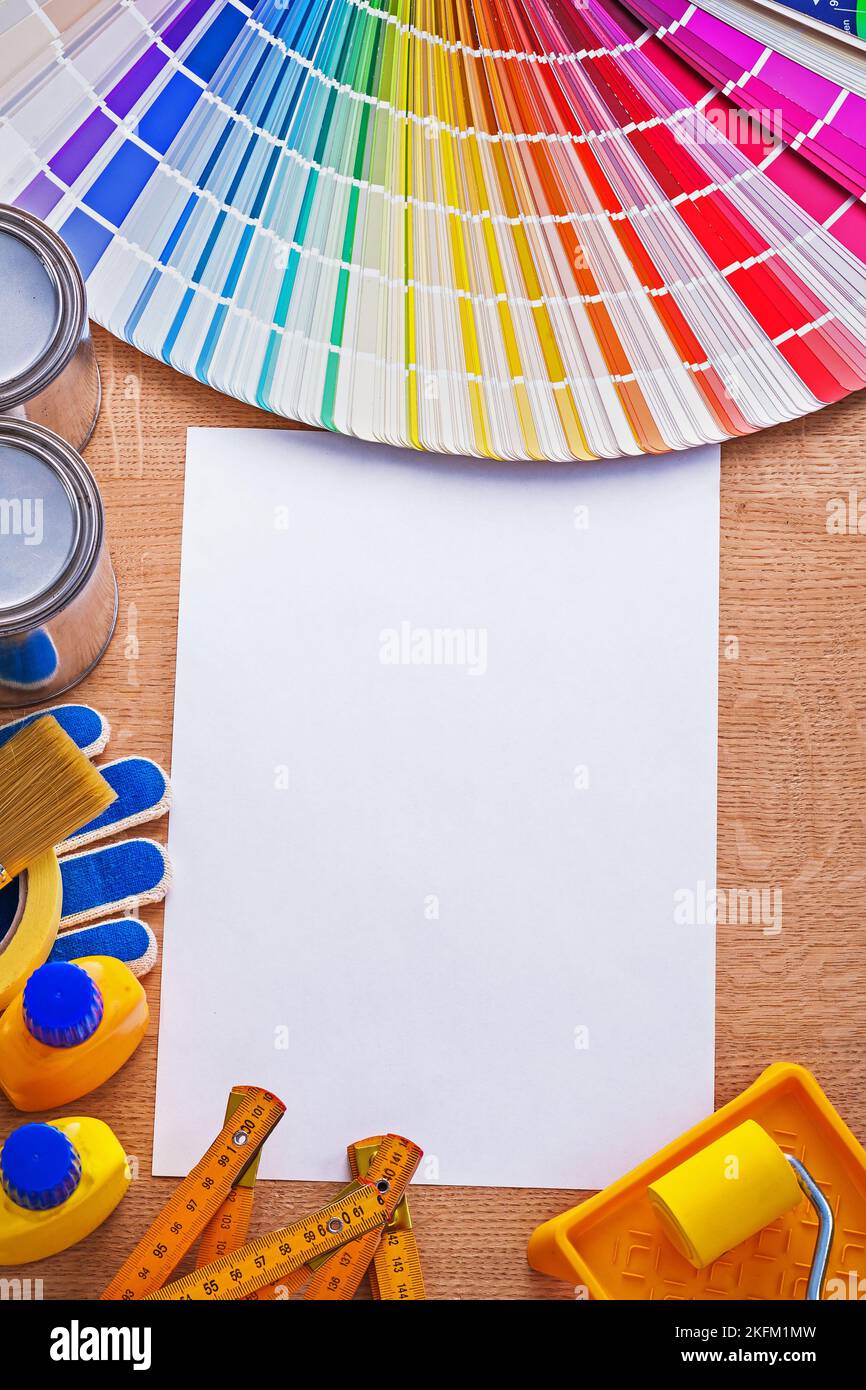 Collection of paint tools and pantone color palette guide on sheet of