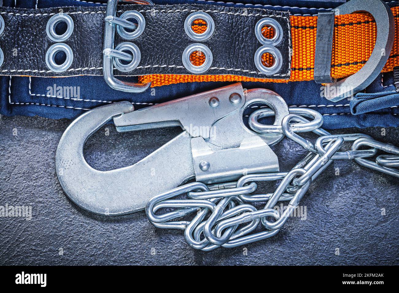 Construction body belt with metal carabiners on black background maintenance concept. Stock Photo