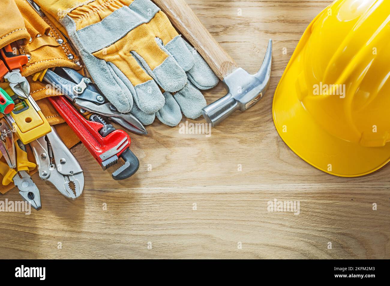 Construction tooling tool belt safety gloves building helmet. Stock Photo