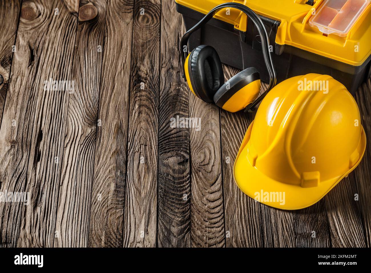 construction tools yellow helmet earphones and toolbox on vintage wood Stock Photo