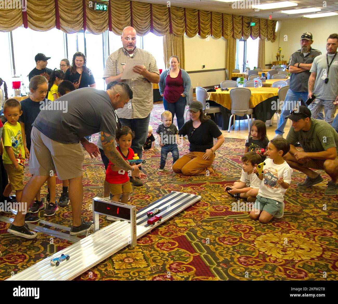 FORT CARSON, Colo. — Family members look on as cars are judged after