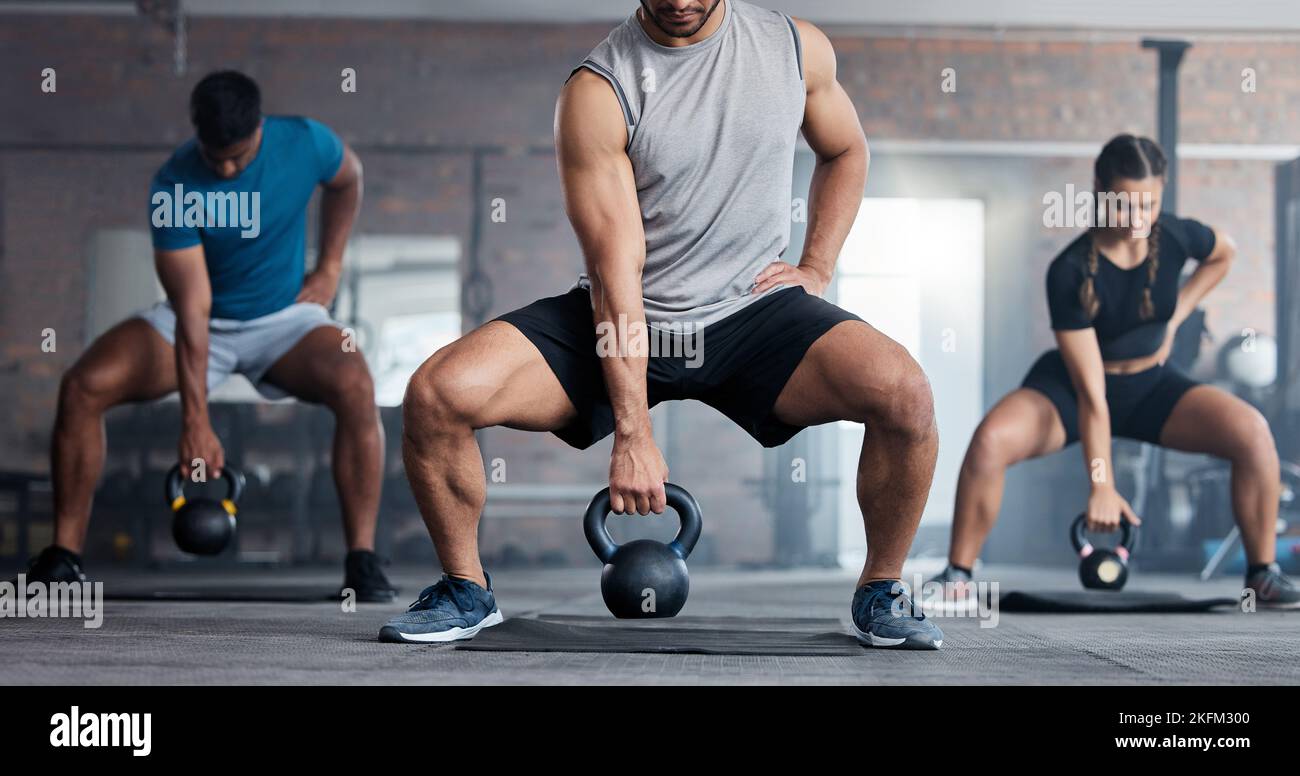 Fitness, weightlifting and kettlebell class for arm workout, exercise or training together at the gym. Active people in sports exercising with kettle Stock Photo