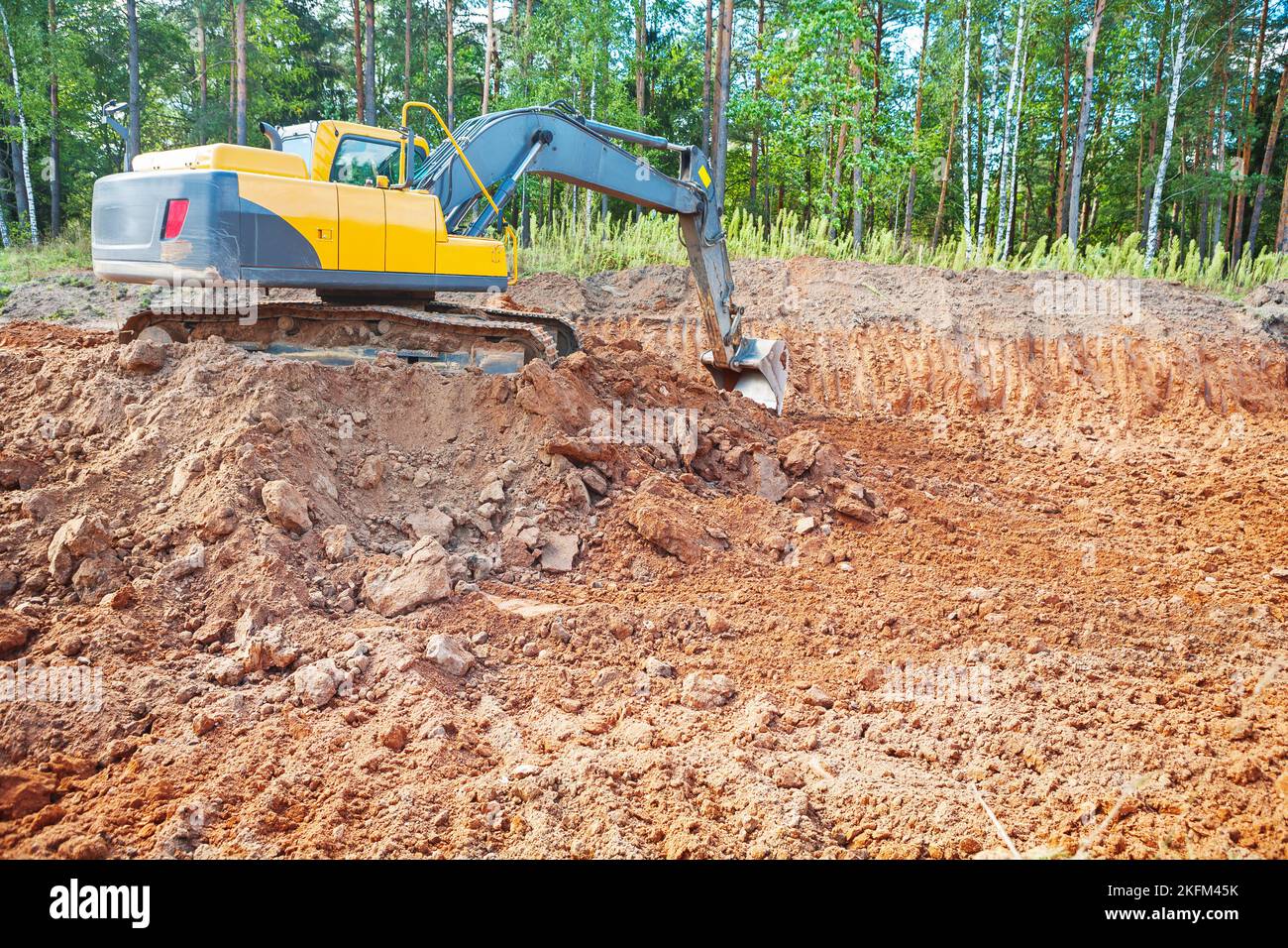 excavator in work on constructon site in forest Stock Photo