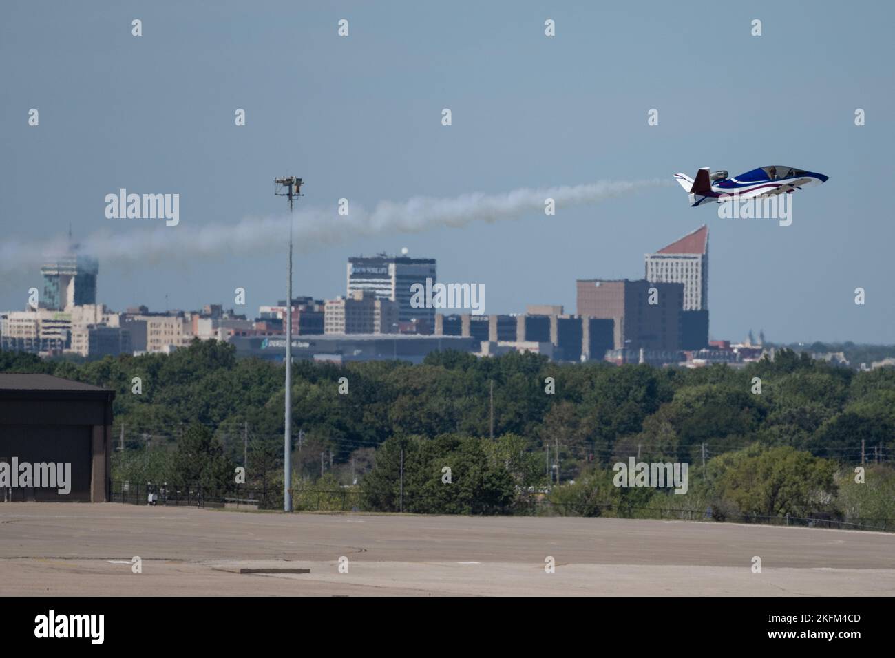 Tom Larkin with Mini Jet Airshows flys by the Wichita skyline during