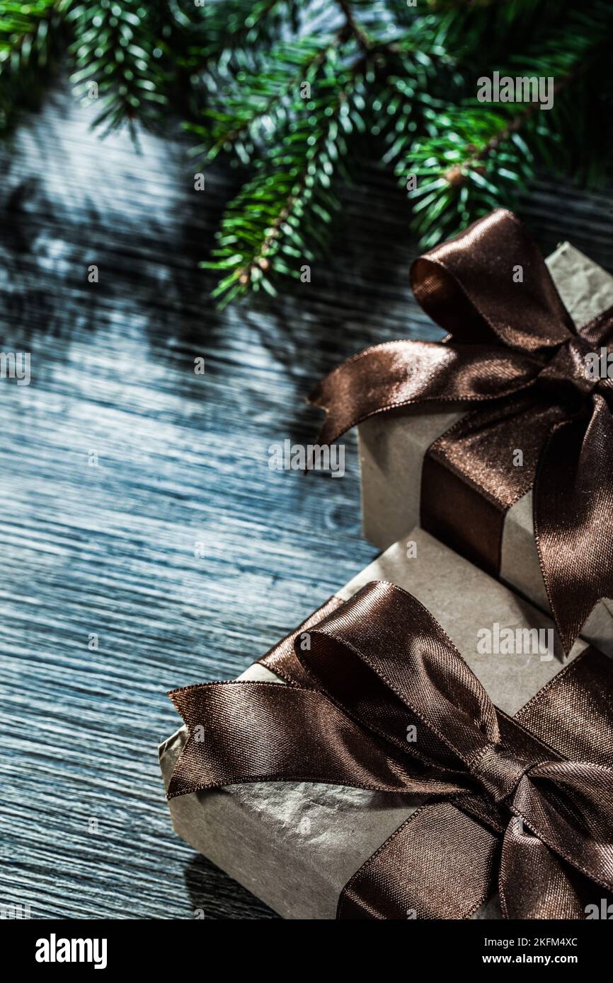 Gift box with ribbon pine branches on vintage wooden board. Stock Photo