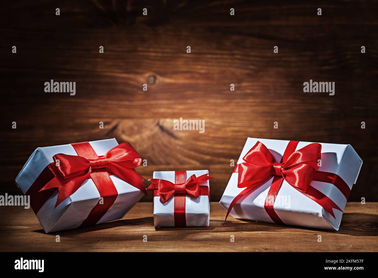 giftboxes with red ribbons on vintage wood Stock Photo - Alamy