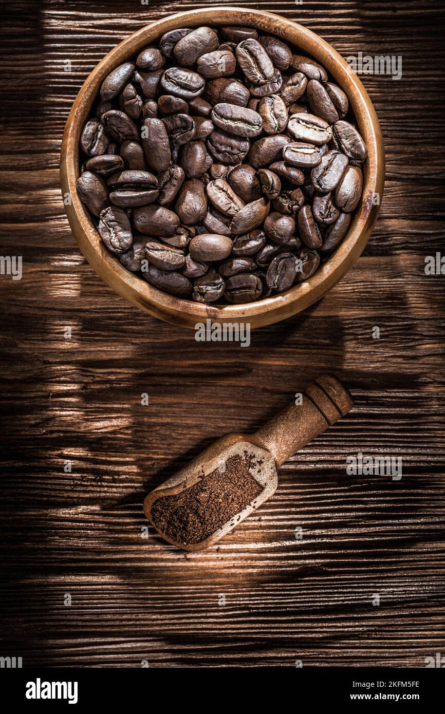 Ground coffee grains bowl scoop on vintage wooden board. Stock Photo