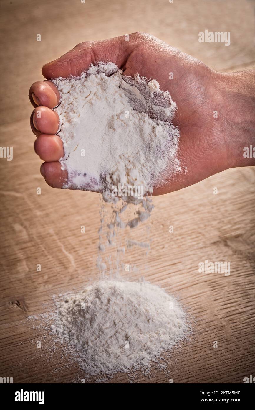 hand pouring flour on table food and drink concept Stock Photo Alamy