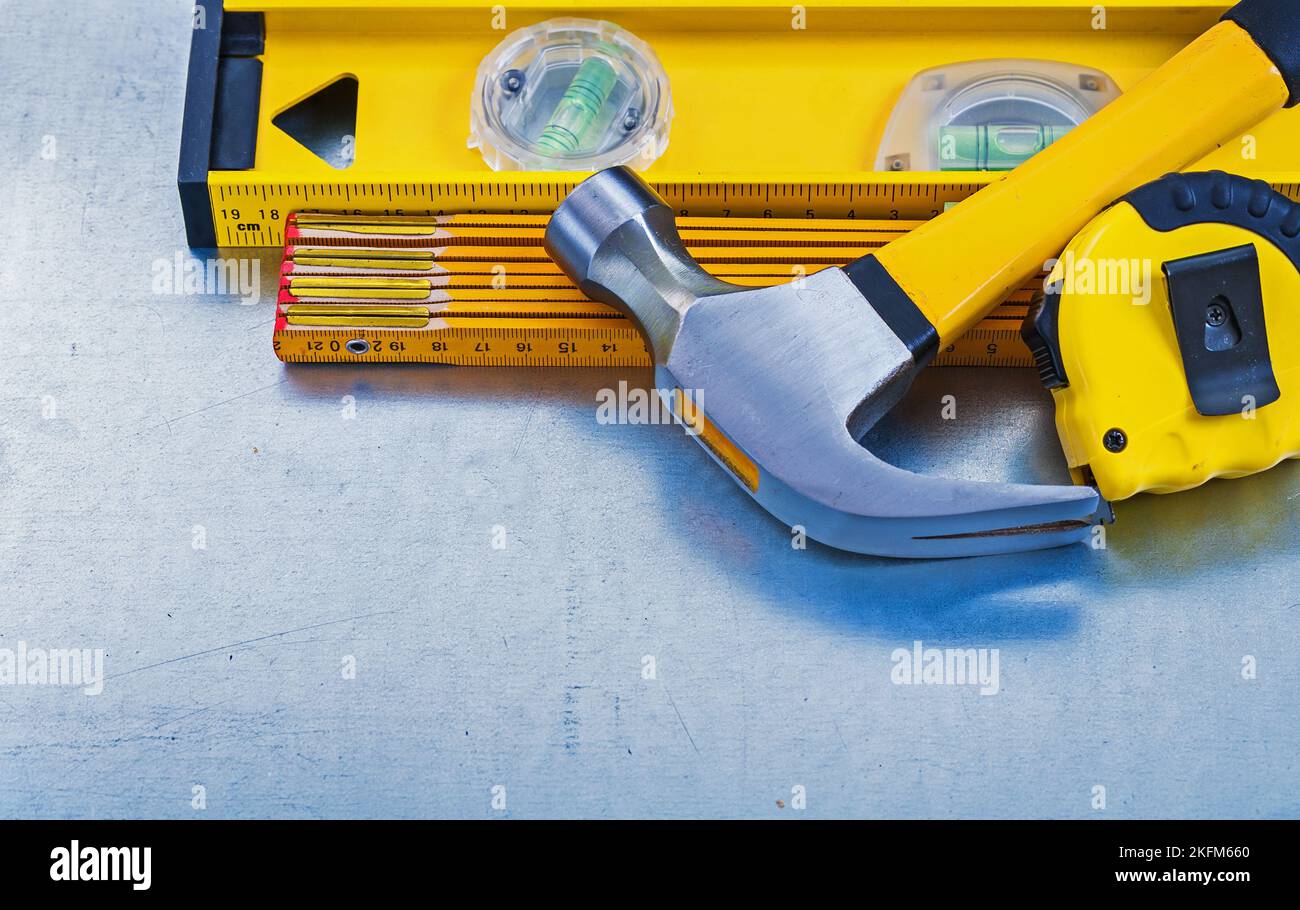 Horizontal view of construction level tape line claw hammer wooden