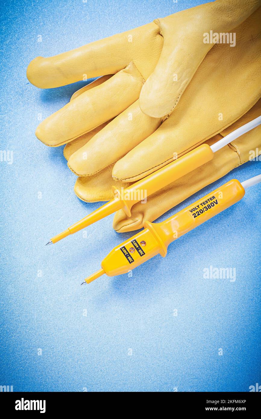 Leather safety gloves electrical tester on blue background electricity concept Stock Photo Alamy