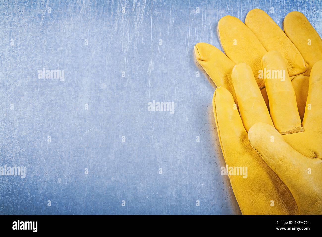 Leather safety gloves on metallic background electricity concept Stock