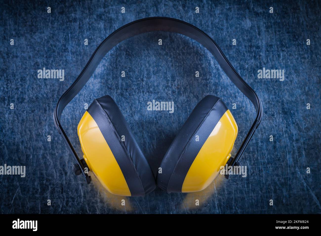 Noise reduction earmuffs on metallic surface construction concept. Stock Photo