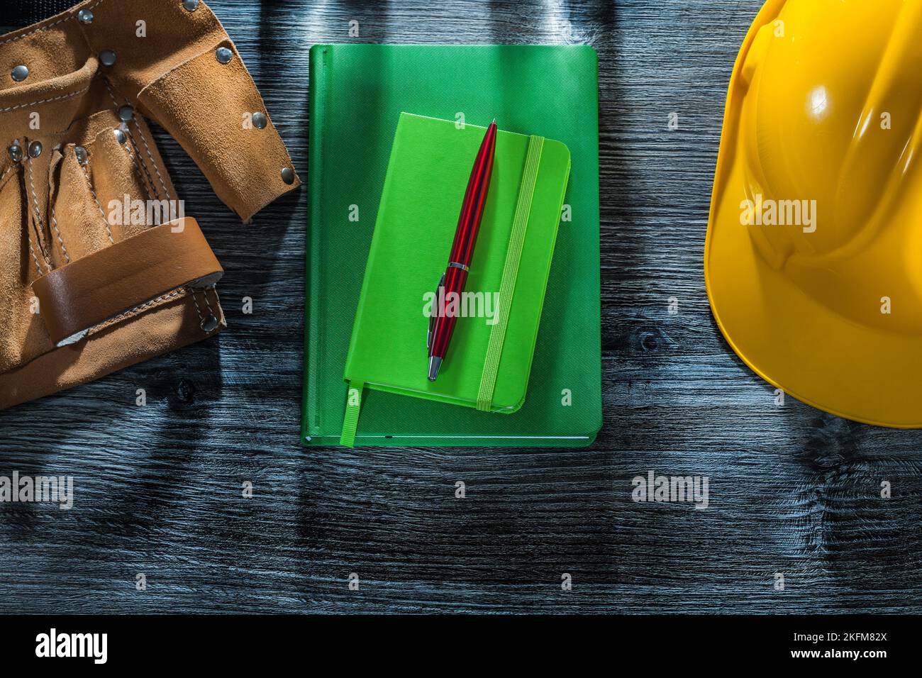 Notebooks pen hard hat tool belt on wooden board Stock Photo Alamy