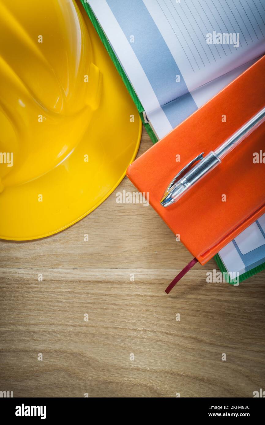 Notepads pen building helmet on wooden board construction concept Stock ...