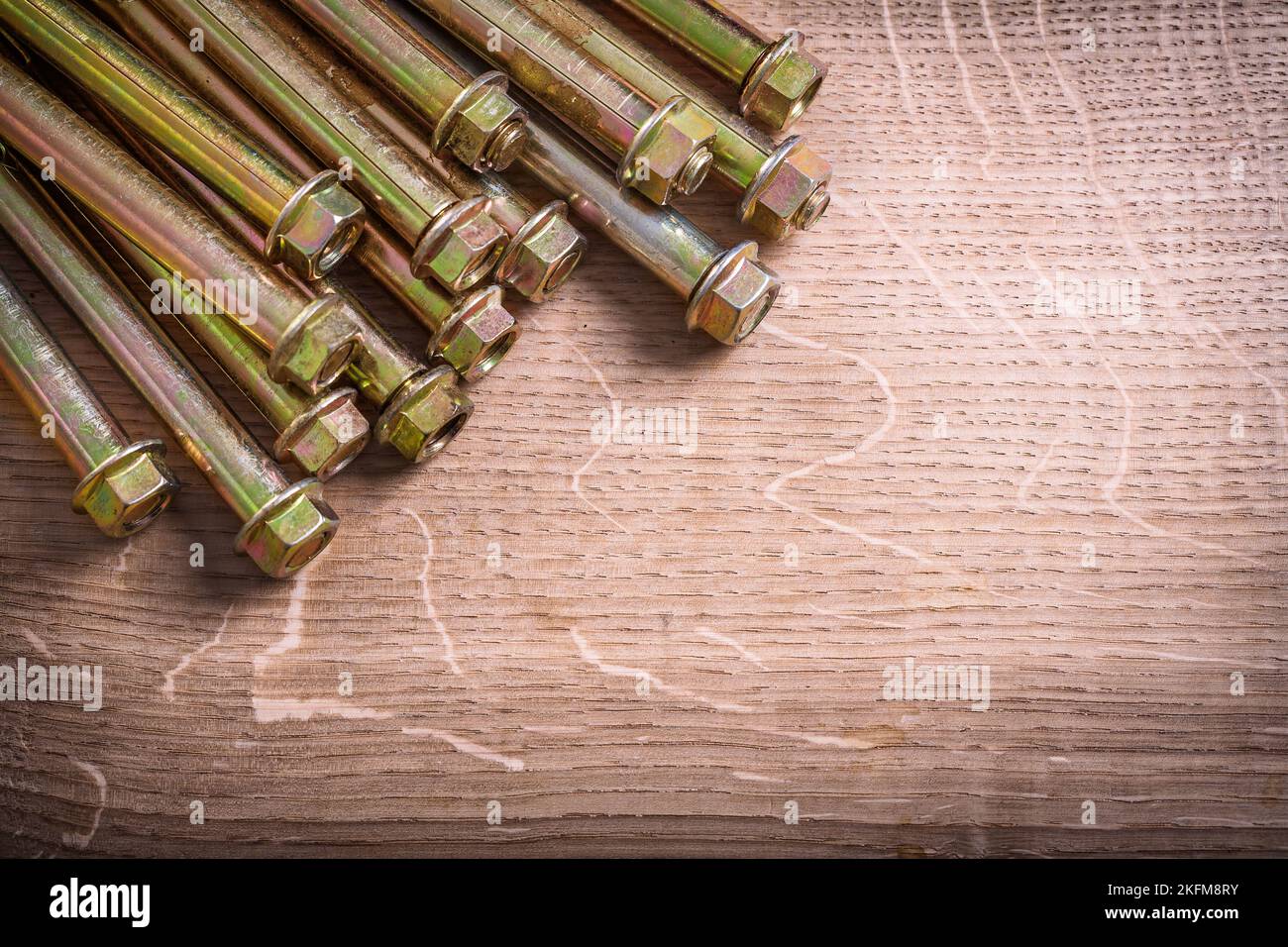 organized copyspace metalic anchors for concrete wall on wooden board