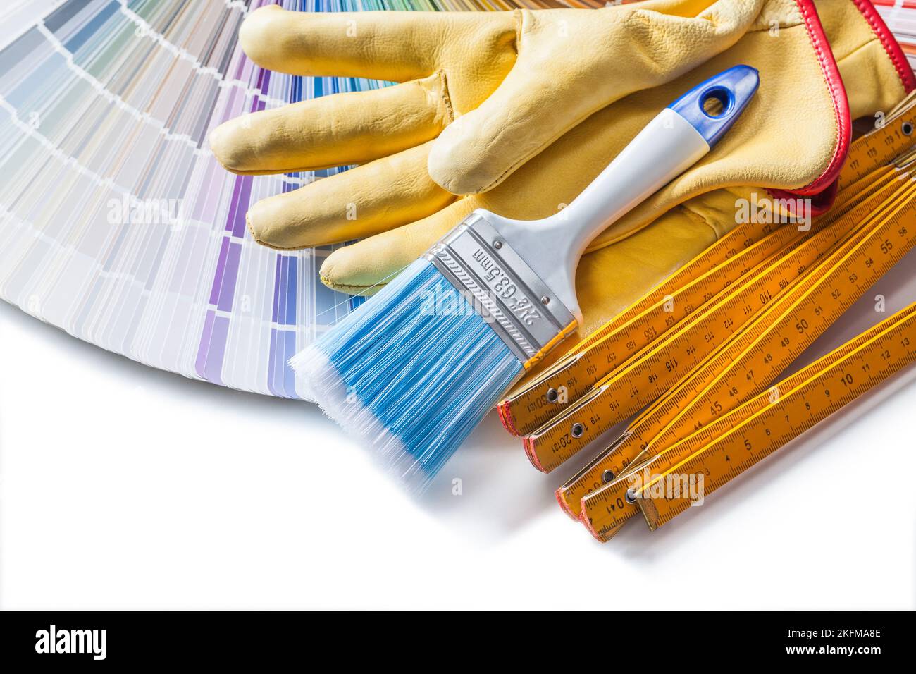 painting tools paint brush working gloves wooden meter and color palette isolated Stock Photo